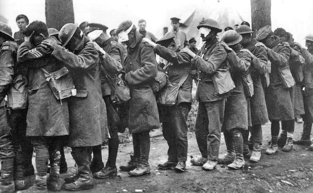 Blinded by gas, British soldiers of the 55th division hold onto each other at an Advanced Dressing Station